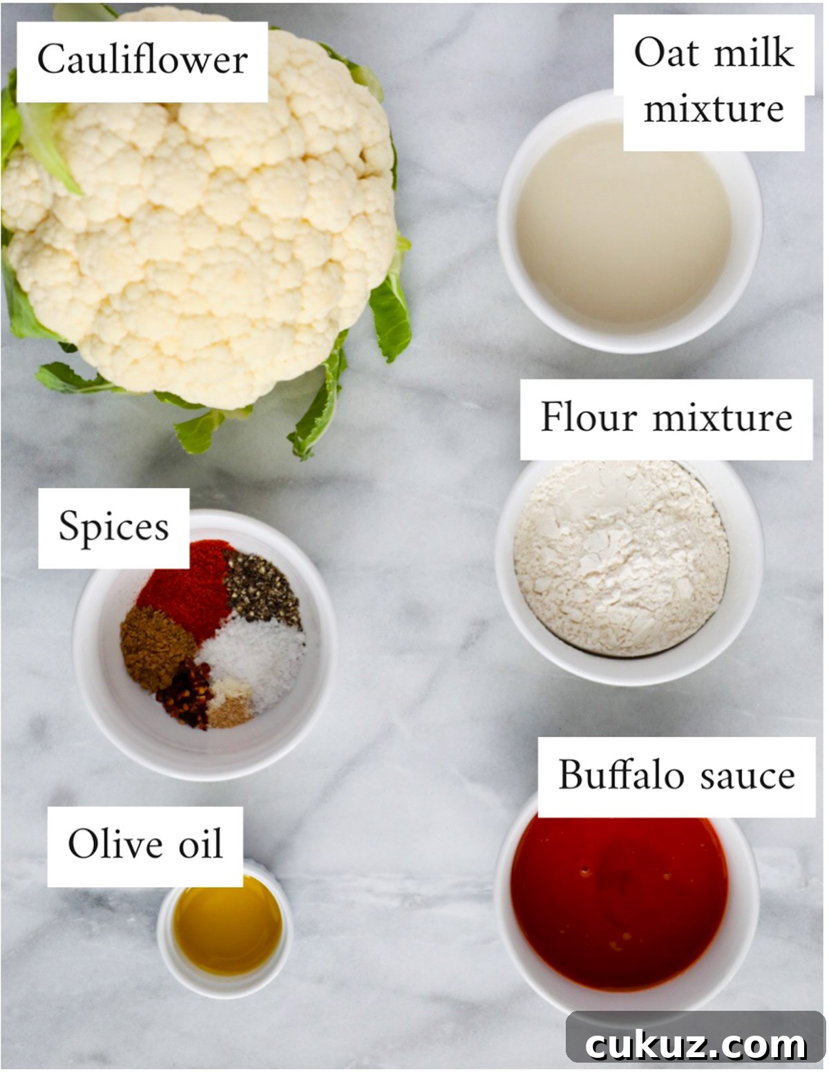 Labeled ingredients including: cauliflower, oat milk mixture, flour mixture, spices, olive oil, and buffalo sauce