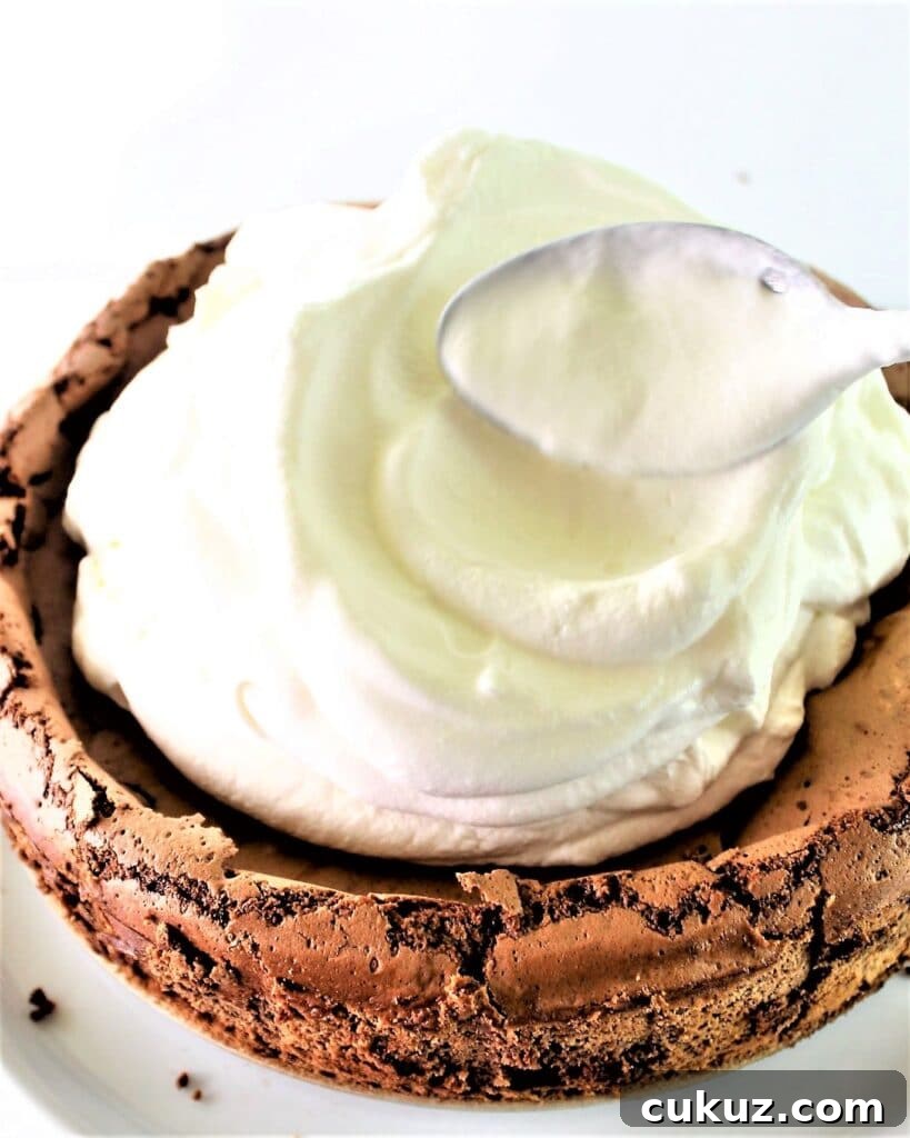 Chocolate Cloud Cake: Naturally Gluten-Free, Light & Fluffy 7 piling the freshly whipped cream onto the chocolate cake