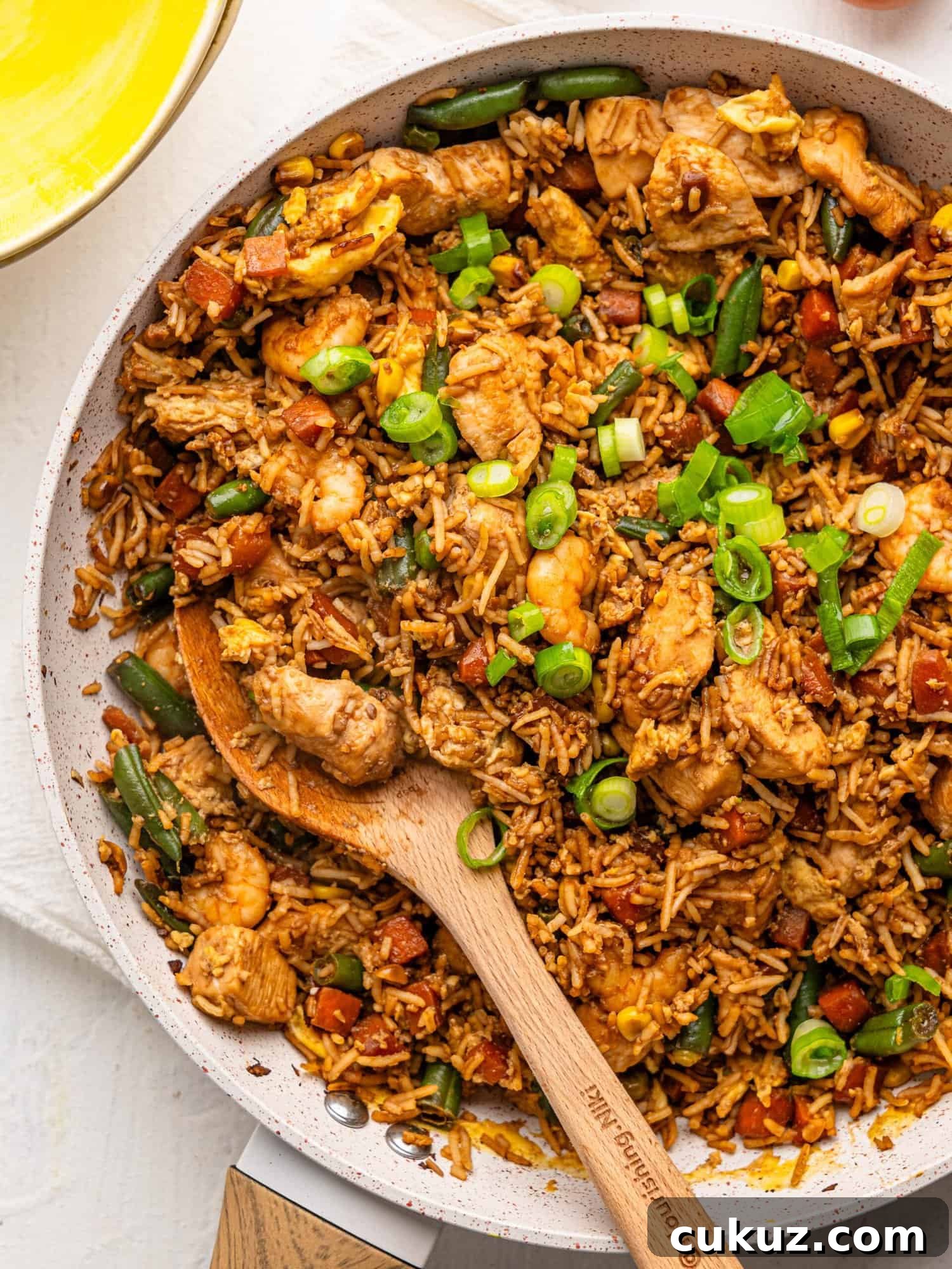 Chicken shrimp fried rice in a frying pan.