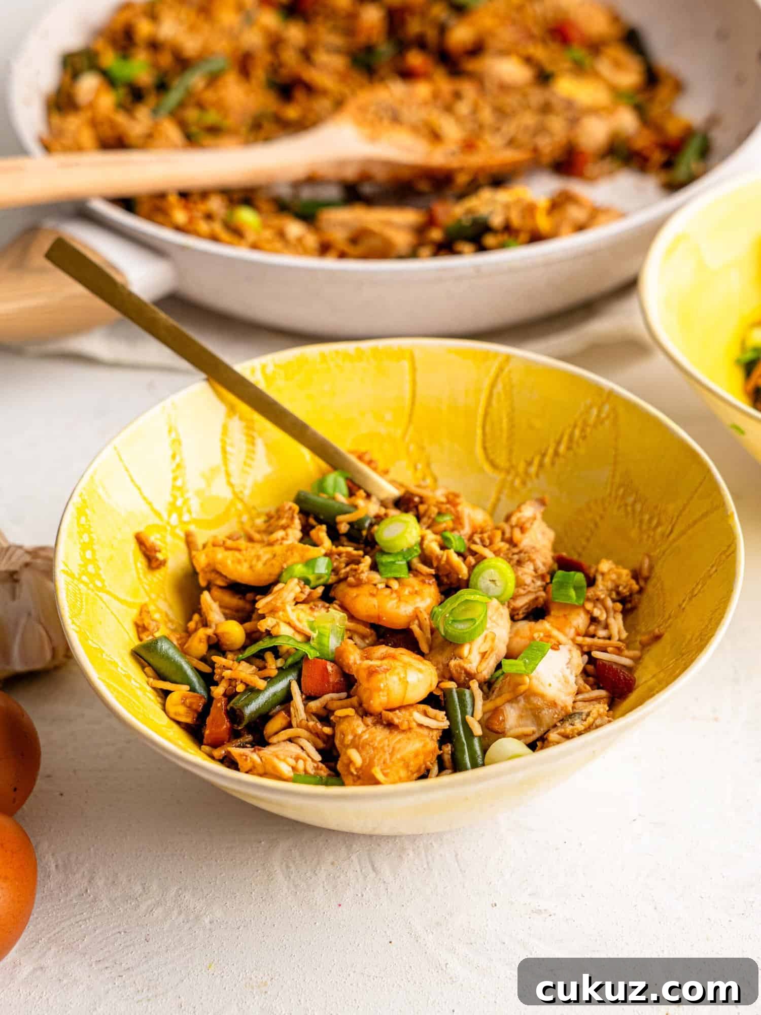 Shrimp and Chicken fried rice in a yellow bowl.