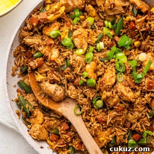 Chicken shrimp fried rice in a frying pan.