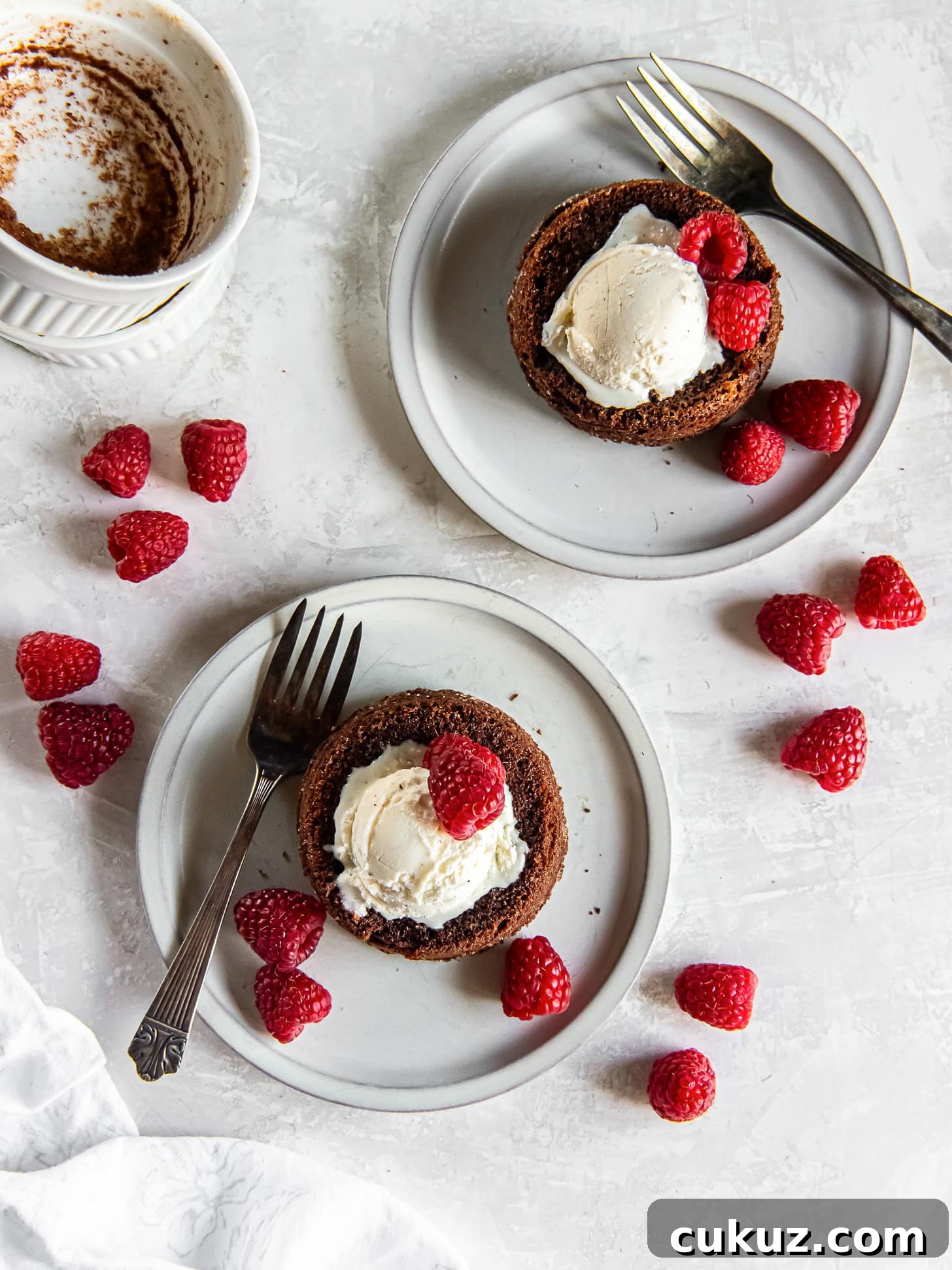 Chocolate lava cakes served on white plates with forks.