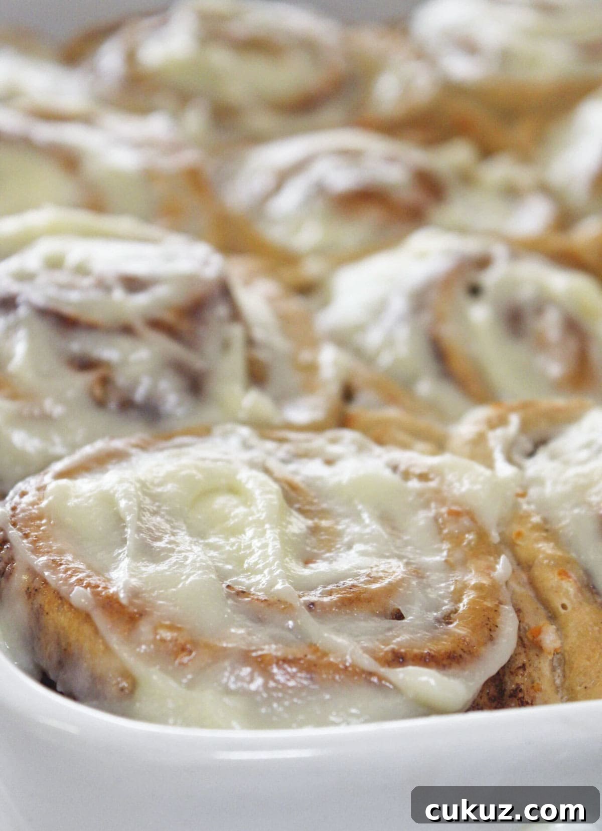Carrot Cake Cinnamon Rolls with Cream Cheese Glaze 8 A dozen carrot cake cinnamon rolls in a 9x13 pan.