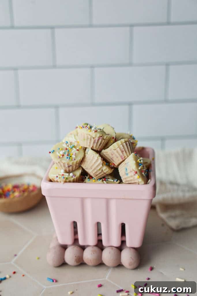 A bowl of dairy-free frozen yogurt bites with white chocolate and sprinkles.