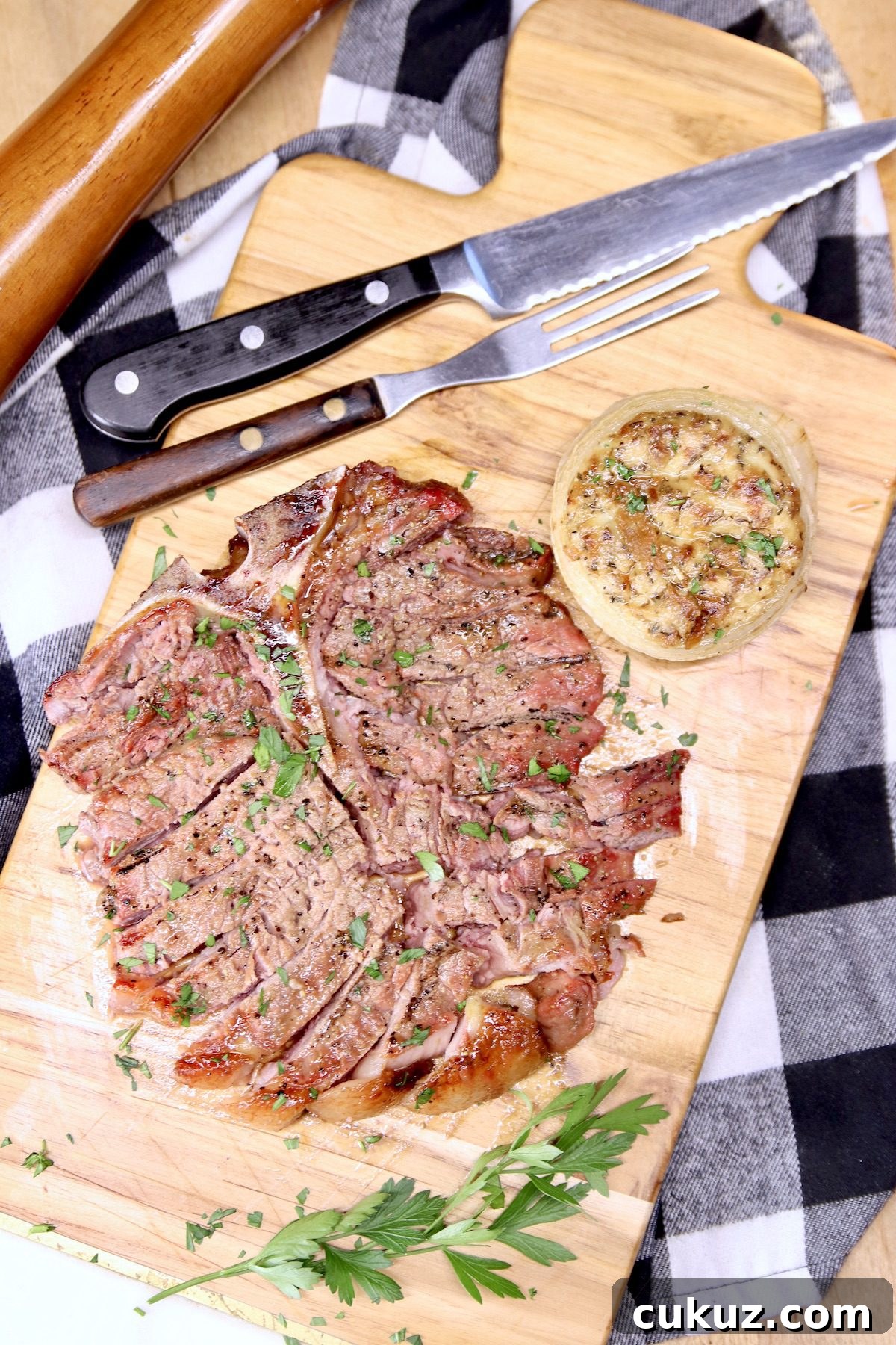 low carb stuffed onions side dish - grilling recipe steak and stuffed onion on a cutting board