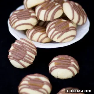 Twix thumbprint cookies on a white plate