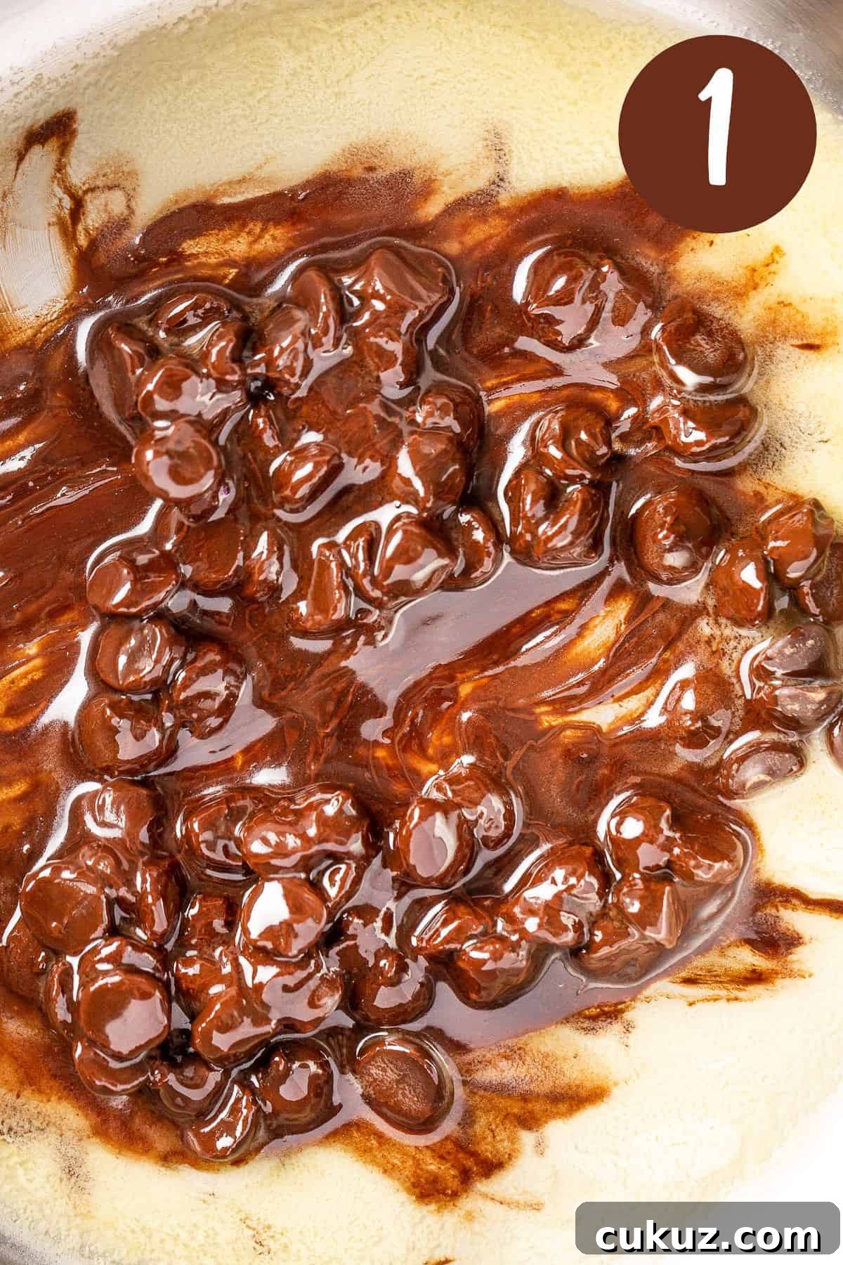 A process photo illustrating step 1: Melting the butter and chocolate chips together.