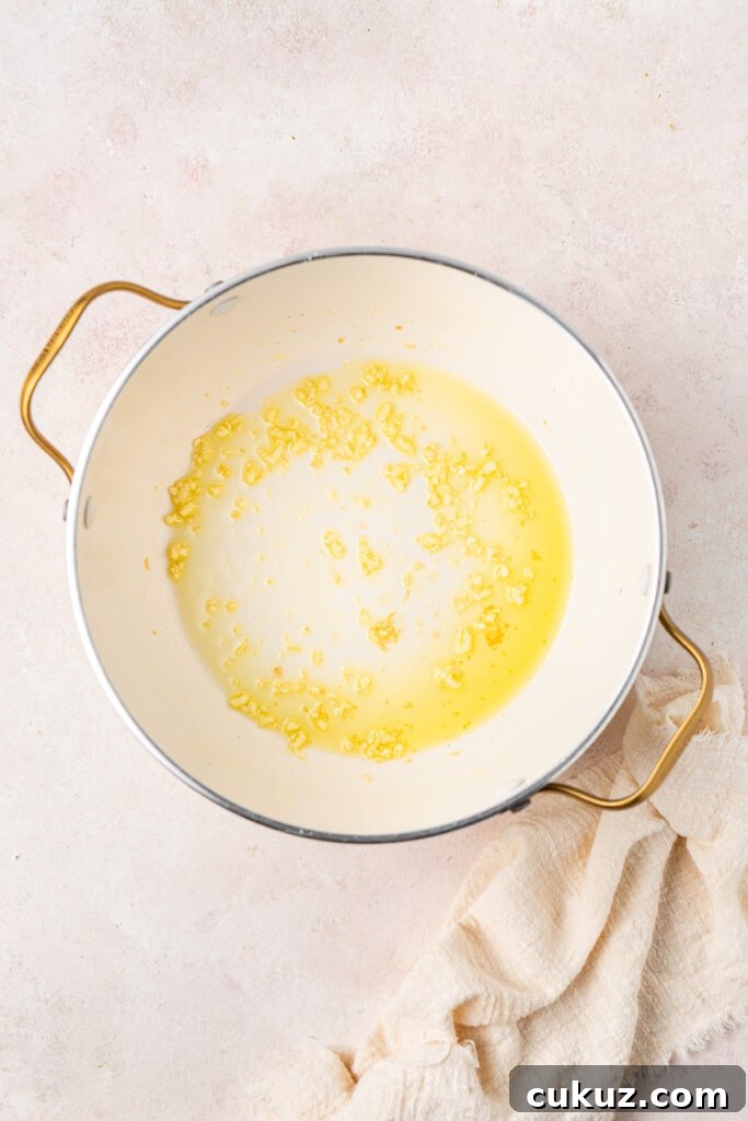 Creamy Dairy-Free Salmon Tagliatelle Recipe 5 Cooking the garlic and oil in the pot.