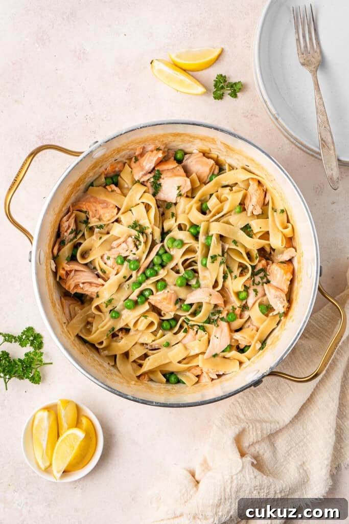 Creamy Dairy-Free Salmon Tagliatelle Recipe 10 Dairy free creamy salmon tagliatelle in a pot with lemon and parsley to garnish.