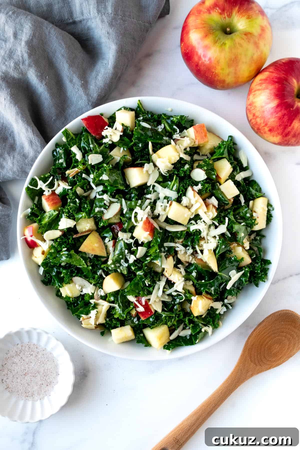 Kale Apple Cheddar Salad in a white serving bowl.