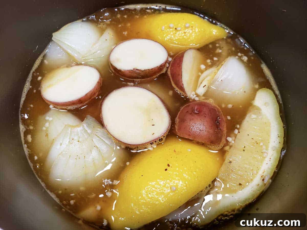 potatoes added to the brown liquid and veggies in a pan.