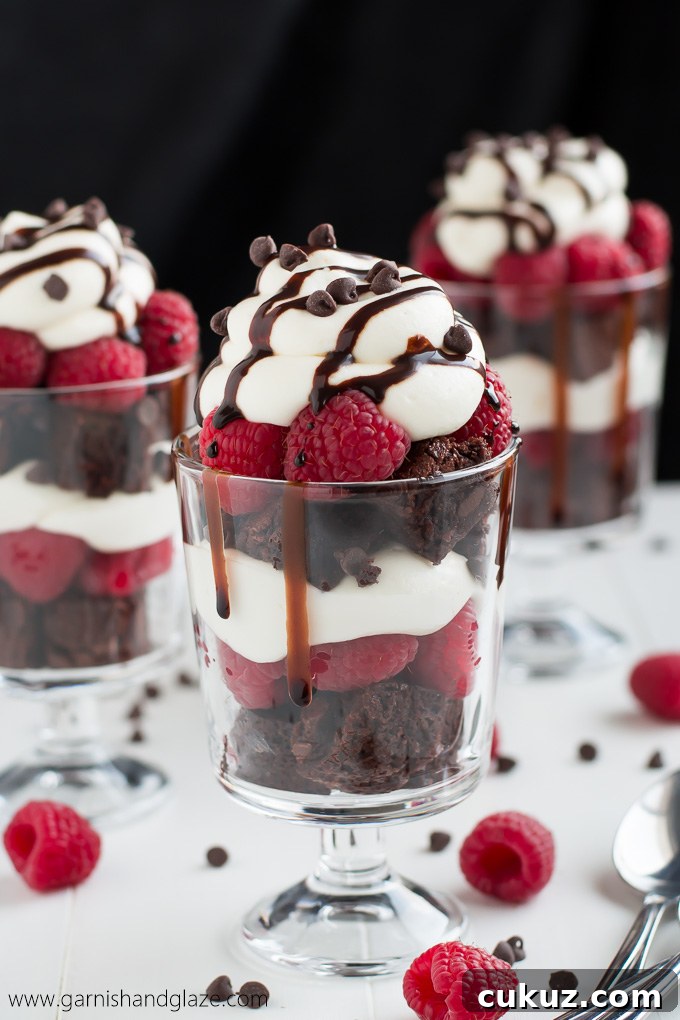 Nothing says "love" like these Raspberry Cheesecake Trifles made with rich chocolate from-scratch brownies, easy no-bake cheesecake filling, and fresh sweet raspberries.