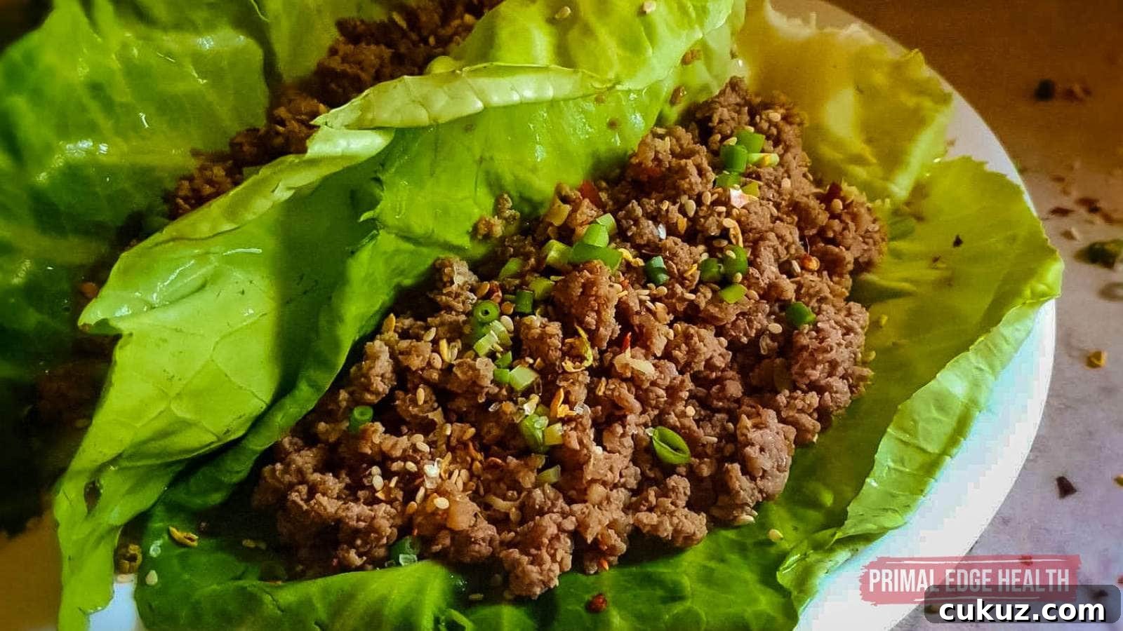 Korean Ground Beef in lettuce wrap on white plate.