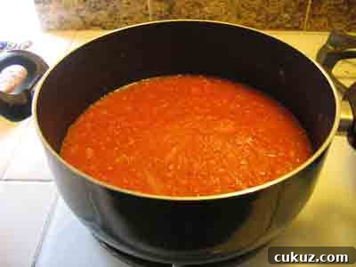 Simmer the tomato sauce.