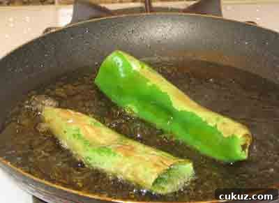 Frying the peppers for piperies me feta.