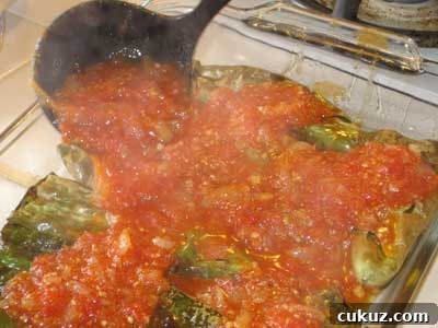 Put the tomato sauce on the peppers.