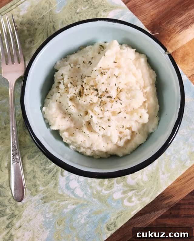 Canned Mashed Potatoes: Quick Tips for Perfect Results 8 A bowl of mashed potatoes from above with a swirled green napikin and a fork using canned mashed potatoes