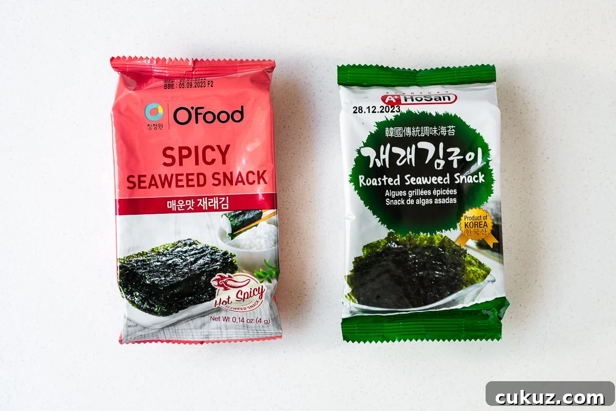 Two different packets of Korean roasted seaweed, a spicy one and a plain salted one.