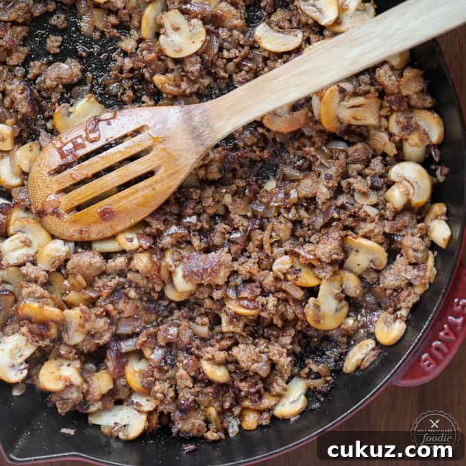 sausage and mushrooms in a pan
