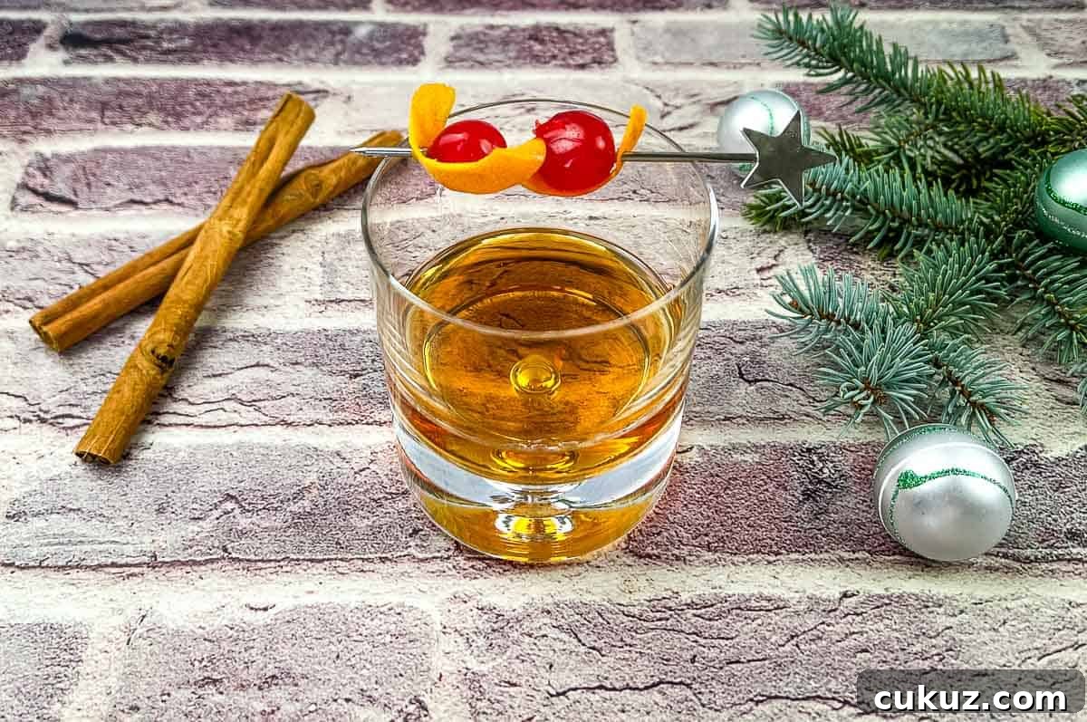 A glass of whiskey with cinnamon sticks on a brick wall.