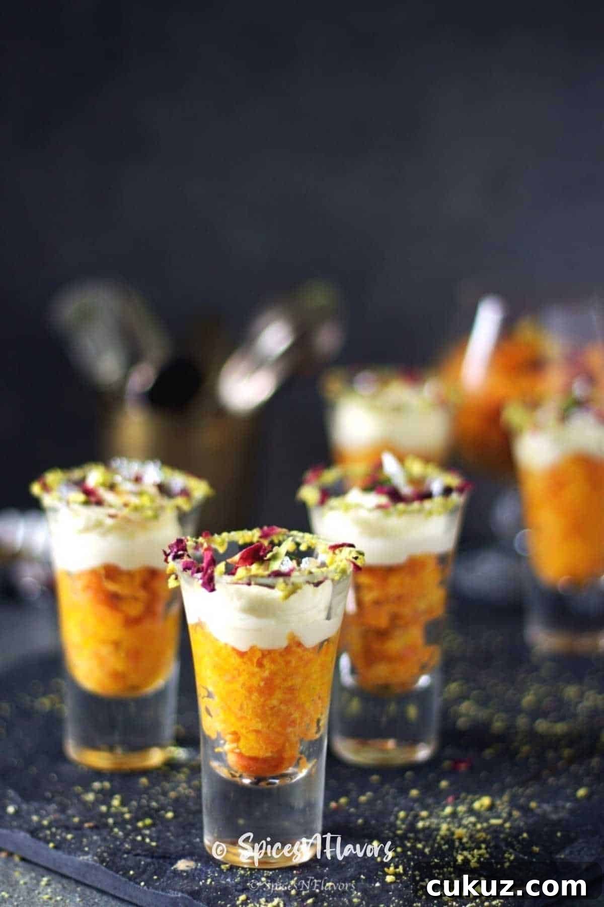 gajar halwa served in shot glasses with whipped cream on top