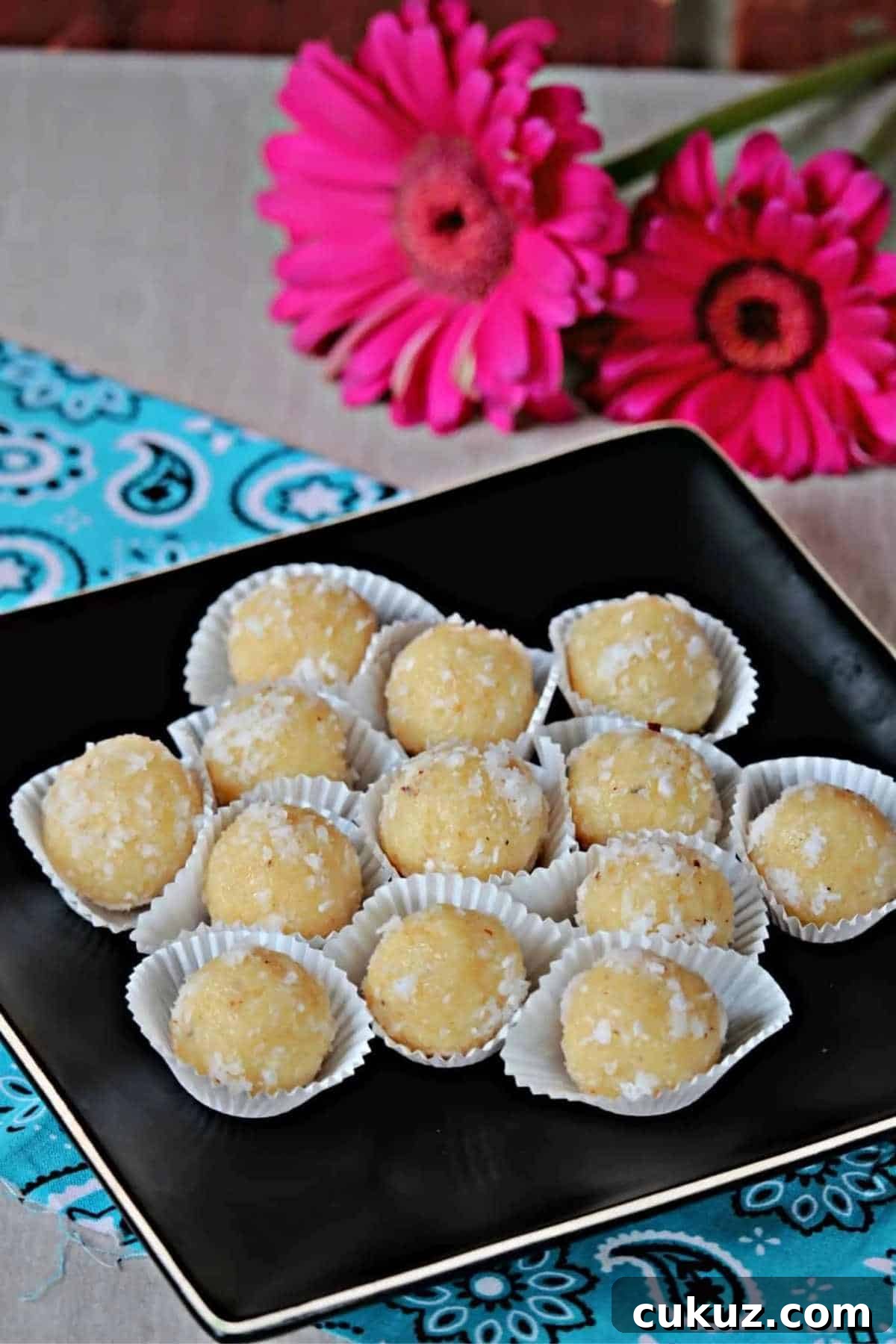 coconut laddu placed on a black plate