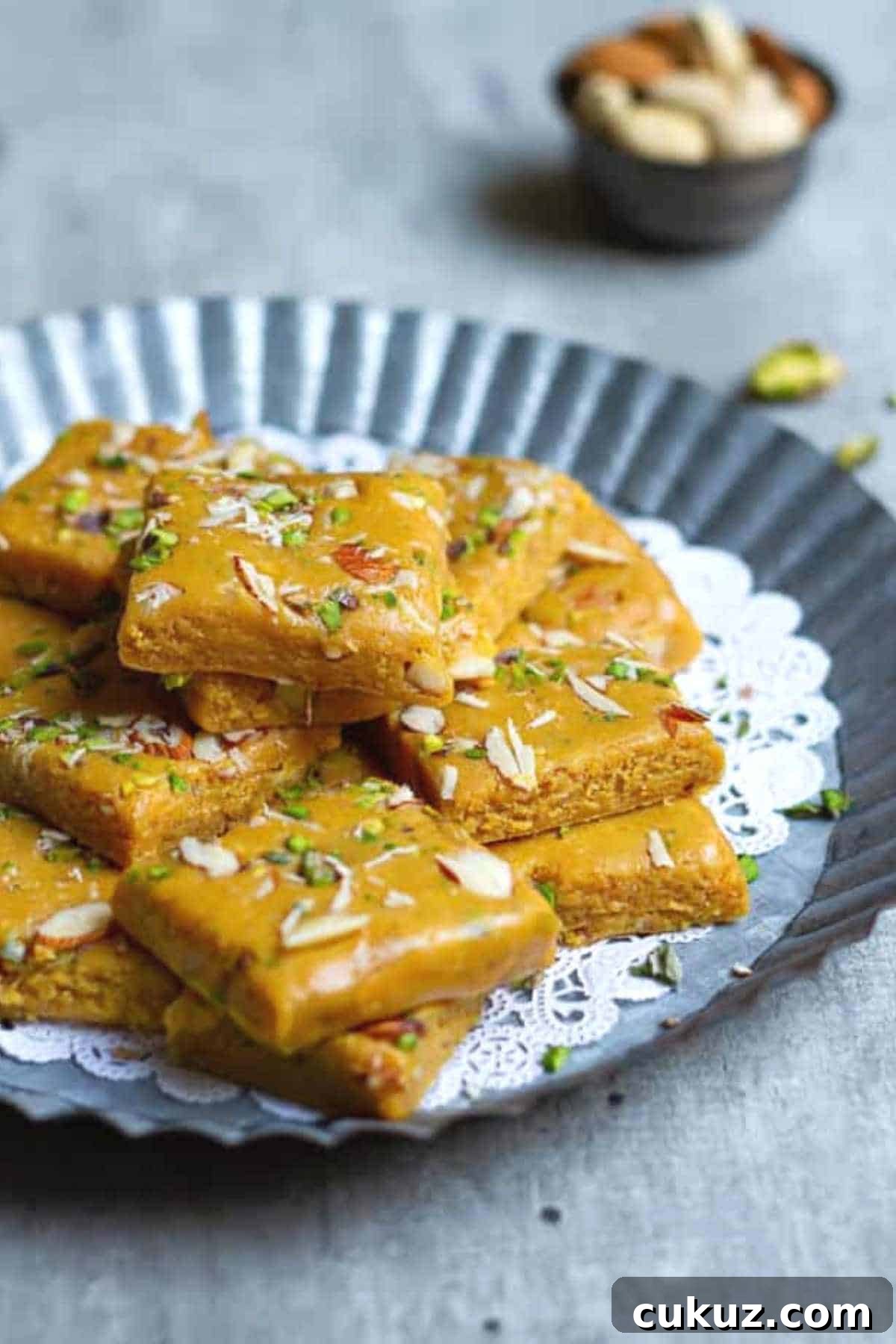 besan burfi squares placed on aluminium tray