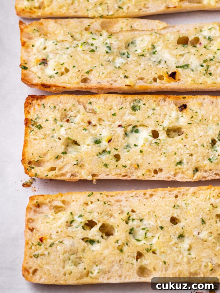 baguette with butter melting into the nooks and crannies