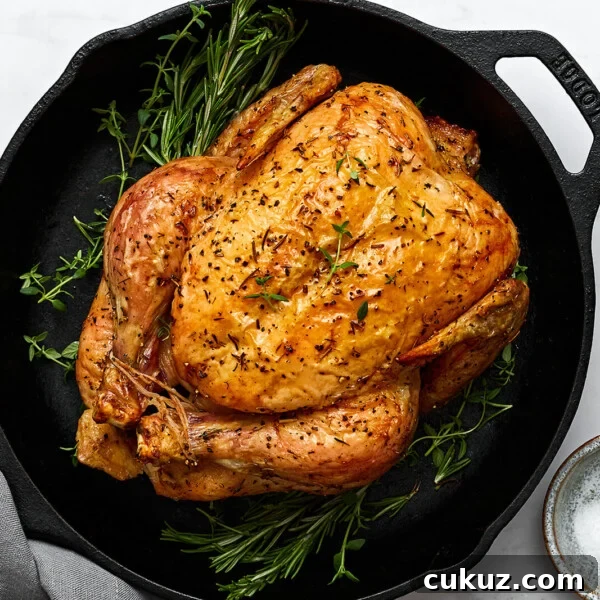 A skillet with roast chicken and herbs