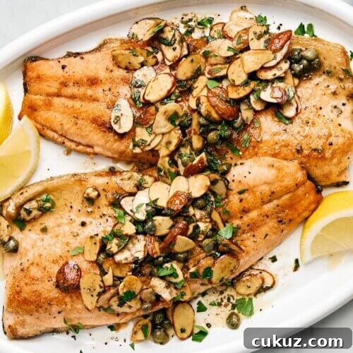 Rainbow trout almondine on a plate.