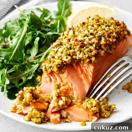 A plate of pistachio crusted salmon