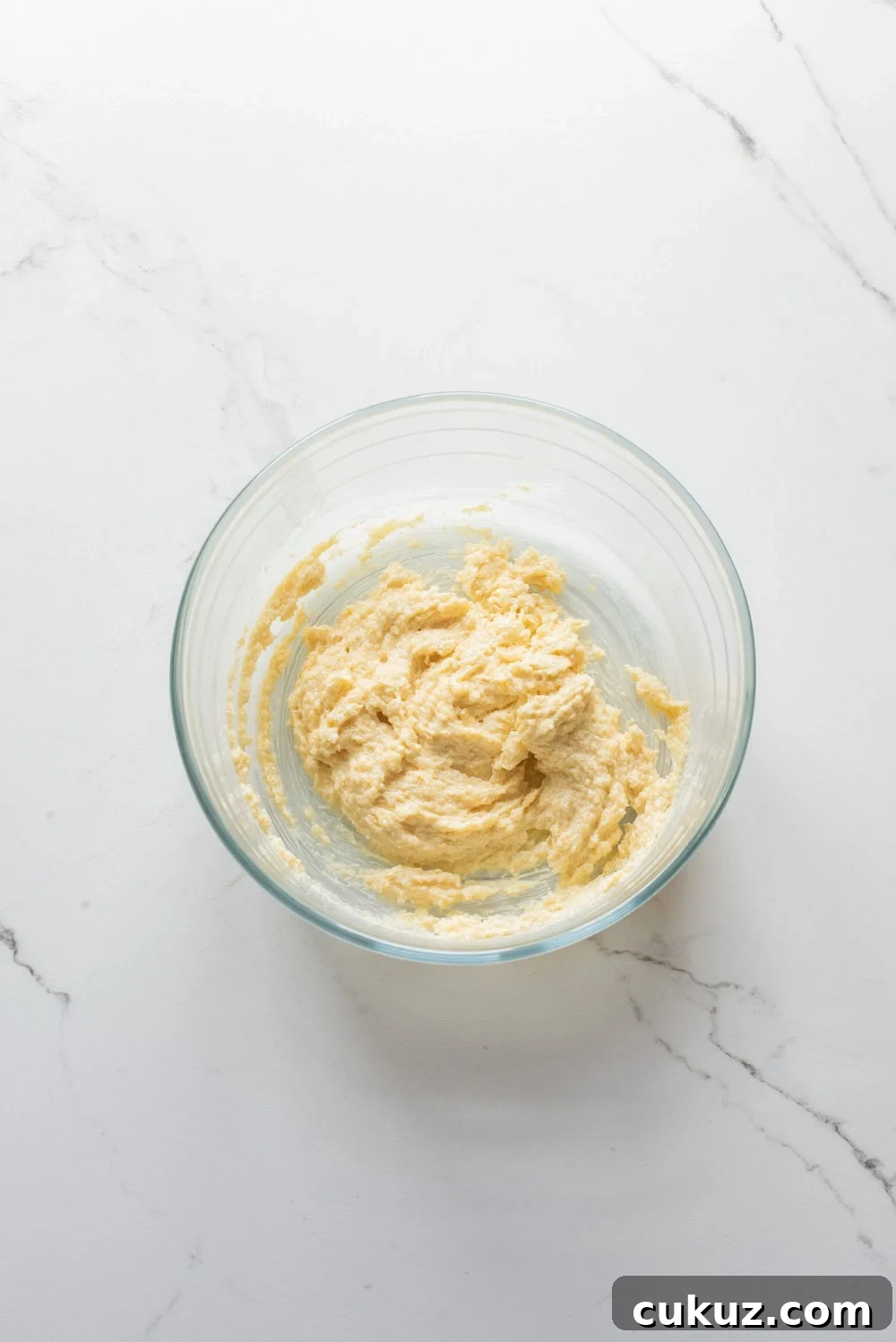 Butter creamed briefly with brown sugar and granulated sugar until dense and combined in a mixing bowl.