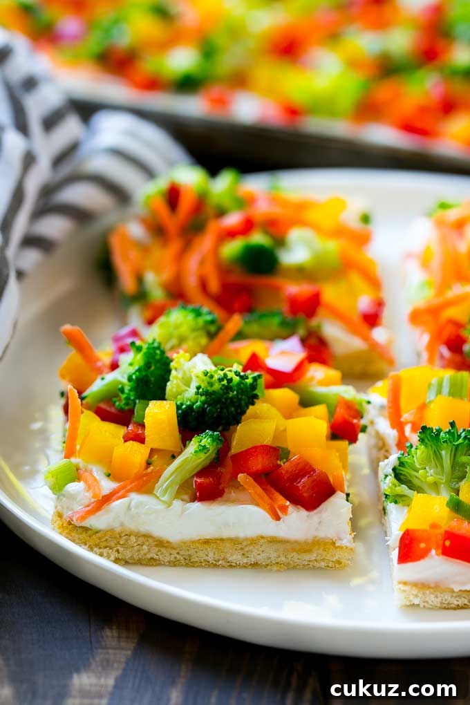Slices of veggie pizza on a serving plate.