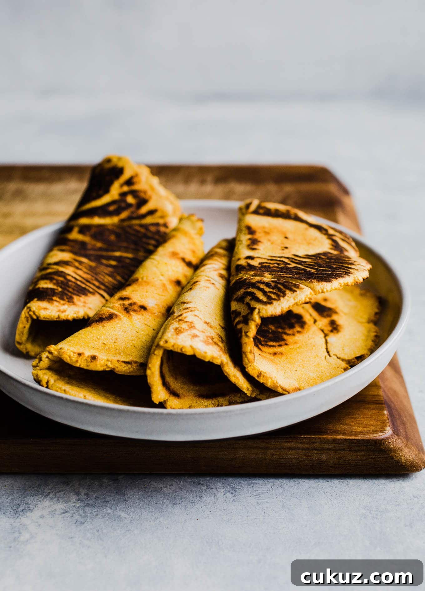 Folded sweet potato flatbreads on plate.
