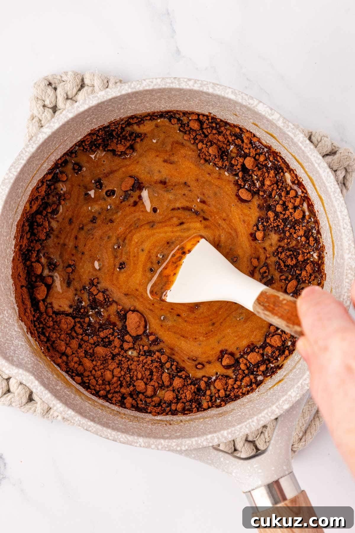 Stirring cacao into mixture