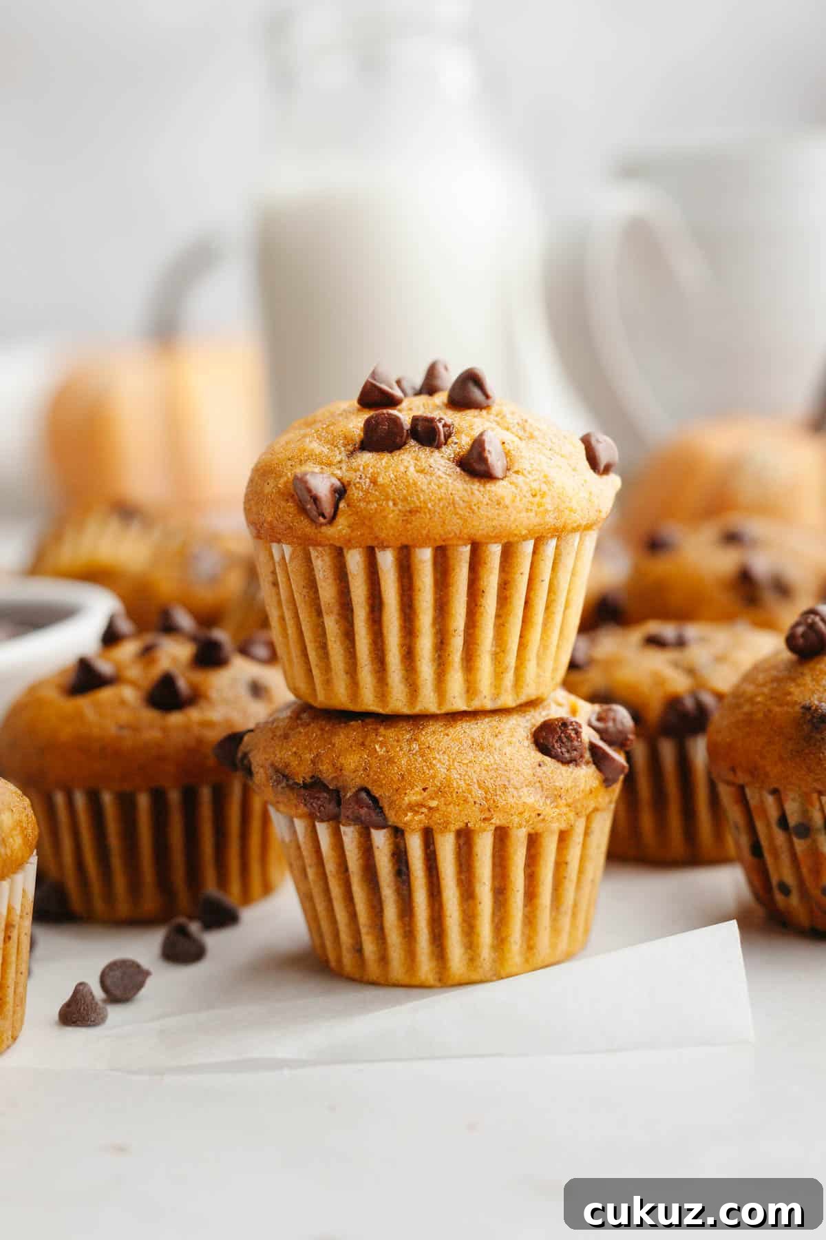 Two pumpkin mini muffins stacked on top of each other.
