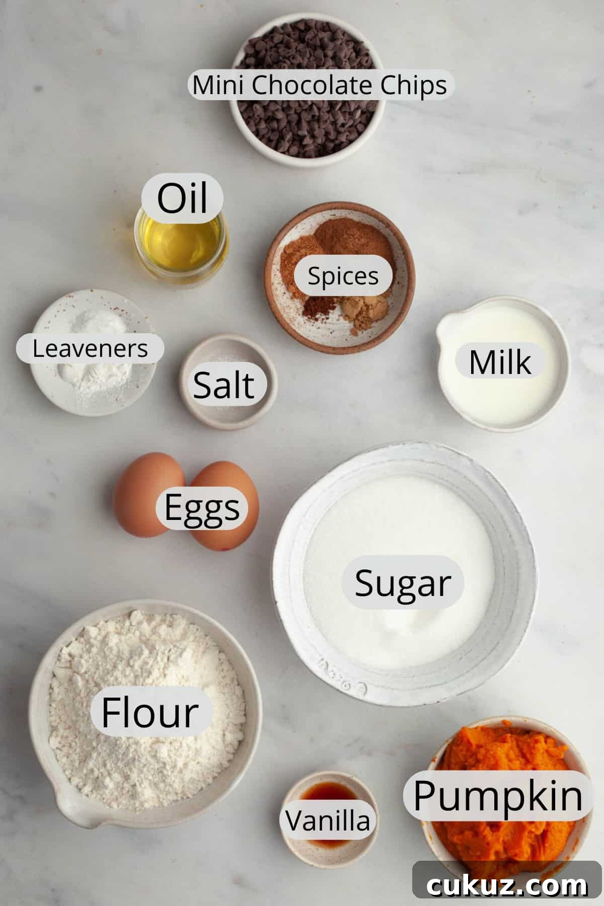 All the ingredients needed to make mini pumpkin muffins with chocolate chips, weighed out into small bowls.