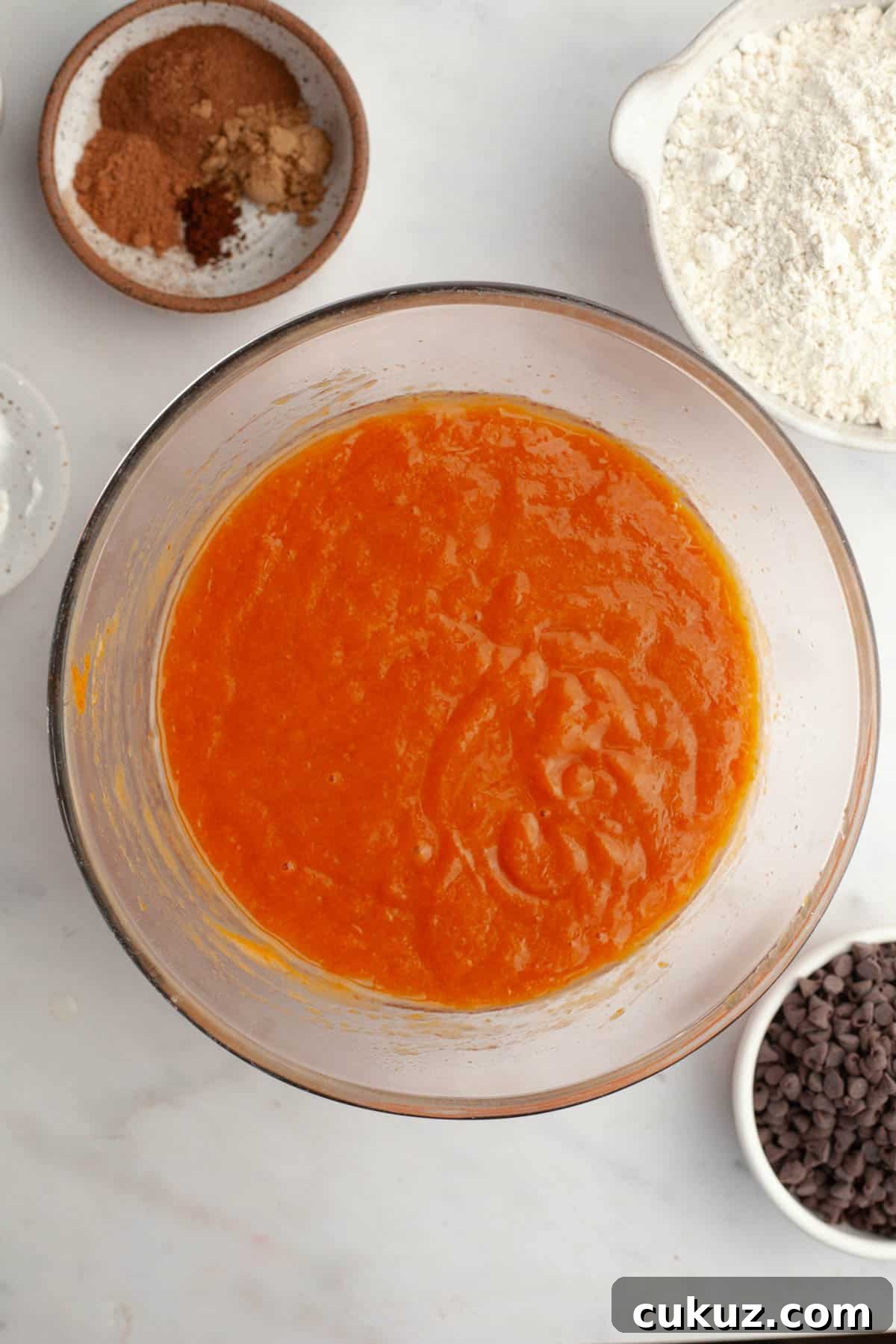 Pumpkin muffin batter in a glass bowl.