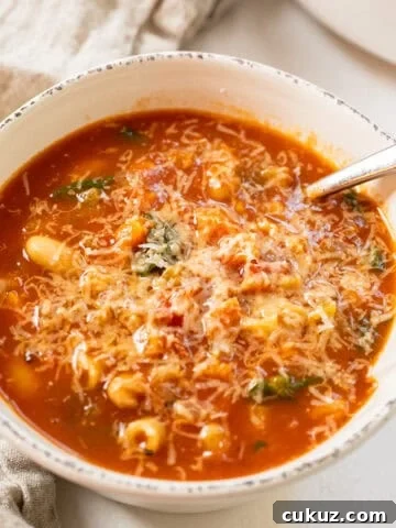 Pasta fagiolo topped with parmesan in a bowl.