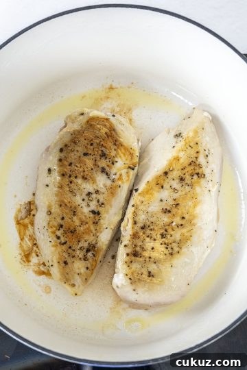 Searing chicken breast until golden brown