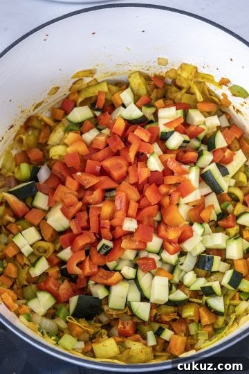 Red pepper and zucchini added to saute