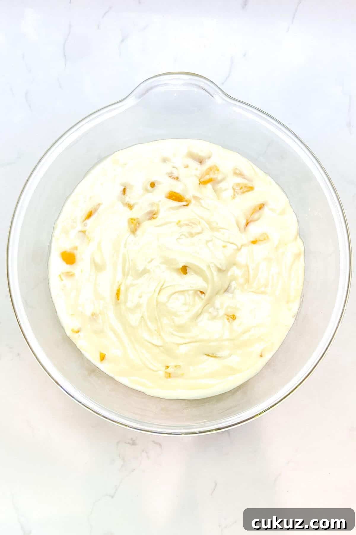 Mixed batter in a large glass bowl.